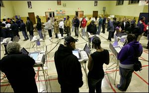 People vote at the polling place inside Fulton Elementary in Toledo, Ohio, Tuesday, November 4, 2008.