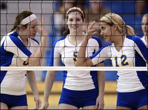 St. Ursula’s Cassidy Croci, left, Katie McKernan and Madison Strall, celebrate scoring a point. The Arrows finished with a 28-1 record last year.