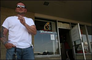 Jimmy Wolff has a smoke outside of Debi's Southwyck Lounge in this 2008 file photo.