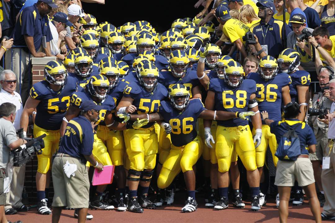 Michigan-players-set-to-storm-field-Kevin-Koger