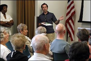 Matt Harrison, the Southern Old Orchard Blockwatch captain, speaks during a standing-room-only meeting on Monday at which neighborhood crime was discussed.
