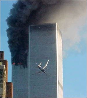 A jet airliner is lined up on one of the World Trade Center towers in this Sept. 11, 2001, file photo.