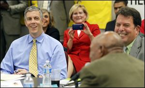 U.S. Secretary of Education Arne Duncan, left, listens during a mock peer review session at the Toledo Federation of Teachers headquarters on South Byrne Road. His visit Wednesday was part of a Midwest tour to view reforms.