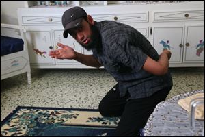 Tunisian Islamist Saber Ragoubi, 28, shows how he was forced to kneel when he first arrived at Morneguia prison and had his teeth kicked out during an interview at his home in Sousse, Tunisia. Tunisia passed anti-terror laws in 2003 and the staunchly secular regime used them to crack down on signs of piety, to protect itself and to prevent the rise of Islamic militancy. It convicted 62 people under the laws in 2006, 308 in 2007 and 633 in 2009, according to the U.N. One of those convicted was Ragoubi. 