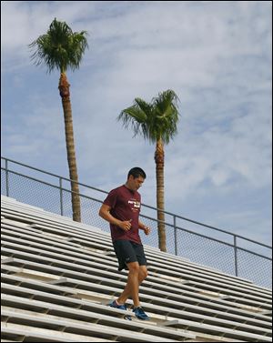 Former Arizona State golfer Pat Moore runs the bleachers at Arizona State University early in Tempe, Ariz. 