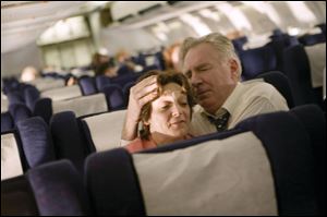 Becky London and Tom O'Rourke as Jean and Donald Peterson comfort one another aboard United Airlines Flight 93 in the unflinching drama 
