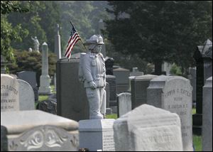 The granite figure of a firefighter in full gear stands over the grave of Michael J. Bocchino at the Green-Wood Cemetery in New York's Brooklyn borough. On Sept. 11, 2001, cemetery workers watched in disbelief from the highest point in Brooklyn as the twin towers of the World Trade Center collapsed after being attacked by terrorists. Green-Wood ultimately became the final destination for 79 victims of the attack, including Bocchino, 45, who belonged to Brooklyn's Battalion 48.