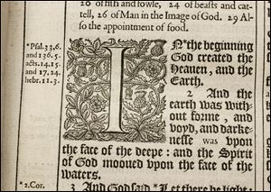 The detail of a page in one of two 400-year-old first editions of the King James Bible at the Toledo Museum of Art shows a thistle-and-rose pattern and notes.