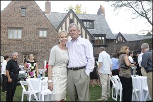 Hostess Barbara Steele, left, and honorary chairman George Chapman, right, at the Perrysburg riverfront home of Ms. Steele and Alan Kimpel.