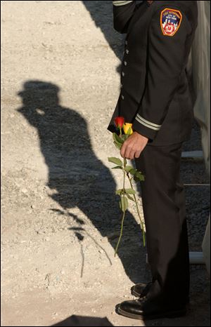 A New York Fire Department firefighter salutes during memorial ceremonies at the site of the former World Trade Center on Sept. 11, 2006.