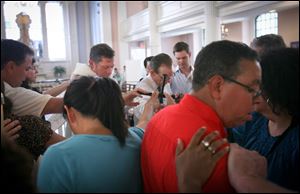 The Rev. Clayton Crawley leads a service at St. Paul's Chapel near Ground Zero. Tourists from all over the world flock by the hundreds each month to pay homage to the church that stood when far mightier buildings tumbled behind it. 