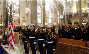 Toledo Fire Department Honor Guard, front, salutes the flag during the presentation of the colors.
