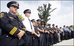 Police Chief William Rhodus, left, joins firefighters and other police officers for the remembrance ceremony at River Centre Park in Sylvania. Sunday's event paid tribute to those who lost their lives in the terrorist attacks and in the armed forces since.