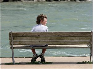 Nick Wetzel, who was on vacation with his family from Cincinnati, watches the activities on Lake Erie on August 3, 2009.