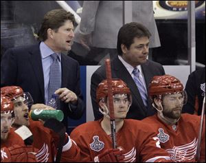 In this May 30, 2009, file photo, Detroit Red Wings head coach Mike Babcock, rear left, and assistant coach Brad McCrimmon, rear right, watch as their team plays the Pittsburgh Penguins. A Russian jet carrying a top ice hockey team crashed just after takeoff Sept. 7, 2011, killing at least 43 people, including McCrimmon, and leaving two others critically injured. 