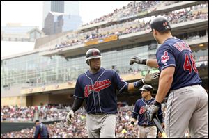 Cleveland Indians' Travis Hafner, right, congratulates teammate Carlos Santana after he hit a two-run home run during the second inning of a baseball game against the Minnesota Twins Saturday.
