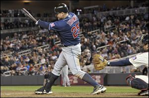 Cleveland Indians' Jim Thome follows through as he hits a solo home run off Minnesota Twins' Joe Nathan during the ninth inning of a baseball game on Friday, in Minneapolis. Cleveland won 7-6.