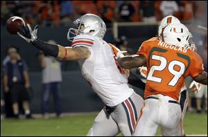 Ohio State tight end Jake Stonebuner can't come up with a catch in the end zone at Miami's JoJo Nicolas defends.