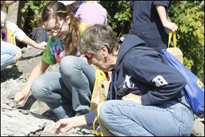 Kyleigh Pero, 13, left, of Graytown, Ohio, looks for fossils with her grandmother Sharon Pauwels of Toledo during the Annual Fossil Fest at Sylvania Historical Village.