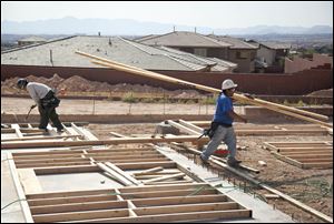 Carpenters work on the frame of a new home under construction in Las Vegas. 