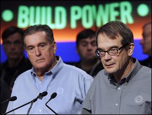 United Auto Workers president Bob King, right, speaks during a news conference as vice president Joe Ashton, left, listens in Detroit, Tuesday, Sept. 20, 2011.