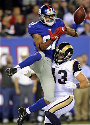 Giants wide receiver Domenik Hixon is defended by the Rams' Craig Dahl during the second quarter. Hixon caught the pass for a touchdown. 