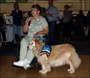 Deb Wagner, with service dog Scarlet, talks to guests about what it means to her to have a service dog.