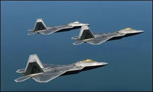 F-22 Raptors fly in formation near Luke Air Force Base, Ariz., in Aug., 2007.