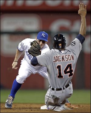 Detroit Tigers' Austin Jackson (14) is caught stealing second base by Kansas City Royals second baseman Johnny Giavotella during the third inning of a baseball game Tuesday, Sept. 20, 2011, in Kansas City, Mo.