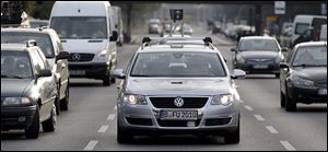 The VW Passat is controlled by a computer as it drives through Berlin. A 360-degree laser scanner is on top of the car, and GPS and other sensors monitor traffic.