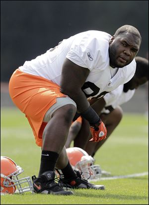 Cleveland Browns defensive tackle Phil Taylor stretches during practice at NFL football training camp in Berea, Ohio.
