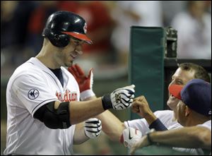 Cleveland Indians' Travis Hafner, left, is greeted at the dugout after a two-run home run off Chicago White Sox starting pitcher Mark Buehrle in the sixth inning of a baseball game on Wednesday.
