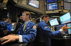 Traders work Thursday on the floor of the New York Stock Exchange.