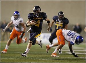 Toledo quarterback Austin Dantin picks up first down during the first quarter of game against Boise State at the Glass Bowl in Toledo, Friday, September 16, 2011.