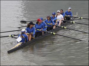 St. Ursula Academy rows to the starting position during the 2011 Frogtown Races Regatta at International Park in Toledo. A total of 47 teams on 323 boats competed in 32 events over a three-mile course on the Maumee River.