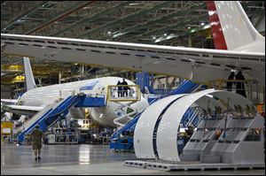 News media groups tour the assembly line of the Boeing Co. 787 in Everett, Wash., Sunday.