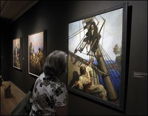 A gallery goer looks at an exhibit of N.C. Wyeth's Treasure Island, Classic Illustrations for a Classic Tale at the Brandywine River Museum in Chadds Ford, Pa. 