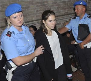 Amanda Knox, center, is escorted to the Perugia court, Italy, Monday, Sept. 26, 2011.