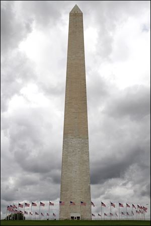 Clouds roll behind the Washington Monument in Washington, Monday, Sept. 26, 2011, before a news conference where the National Park Service updated the extent of damage sustained to the Monument from the Aug. 23 earthquake.
