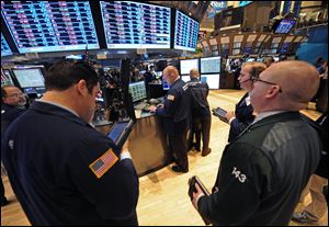Traders work on the floor of the New York Stock Exchange, in New York.