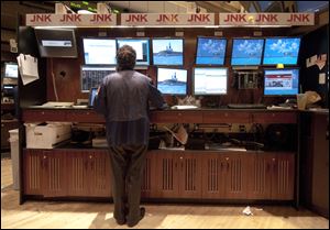 In this Sept. 12, 2011 photo, a trader with JNK Securities works on the floor of the New York Stock Exchange.