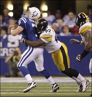 Colts quarterback Curtis Painter (7) fumbles after being hit by Steelers linebacker James Harrison (92) during the fourth quarter Sunday.
