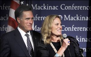 Mitt Romney and his wife, Ann, share the podium before his address to the Republican Leadership Conference on Mackinac Island. His father, George Romney, was Michigan governor in the 1960s.