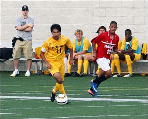 Yadi Aliakbar, taking the ball upfield for Adrian College, is described by his coach as a fireball. He has been around the game of soccer almost since birth. His father, Lee, is the coach at St. Francis and CEO of the Toledo Celtics Soccer Club. 