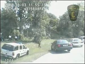 An image of police chasing Brian Lipp from a Toledo police officer's dashboard camera.