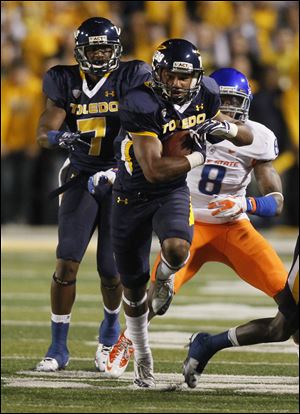 Toledo's Eric Page is pursued Boise State's George Iloka ,8, during the second quarter of their game the Glass Bowl in Toledo, Friday, September 16, 2011.