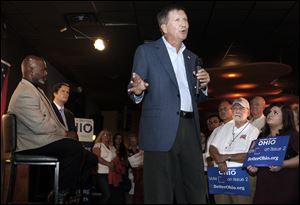 Gov. Kasich speaks to supporters of Issue 2 at the Omni Midwest banquet hall with Toledo Mayor Mike Bell, left, and Sen. Mark Wagoner (R., Ottawa Hills), second from left.
