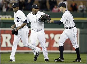 Detroit Tigers outfielders, from left, Austin Jackson, Delmon Young and Don Kelly celebrate a 5-4 win over the Cleveland Indians.