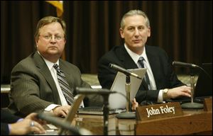 TPS Superintendent, John Foley, left, and TPS Treasurer Dan Romano, right, speak during a special meeting of the Toledo Public School Board on March 3, 2010.