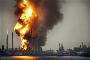 Smoke and flames rise Wednesday from the Royal Dutch Shell's Pulau Bukom offshore petroleum complex in Singapore